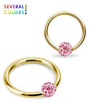 Kullanvärinen lävistysrengas kristallilla